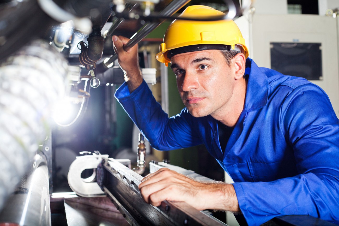 worker examining equipment